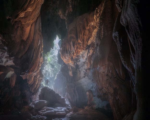 Путешественник внутри карстовой воронки в пещере Тхунг. (Courtesy of Tran Linh via Jungle Boss Tours)