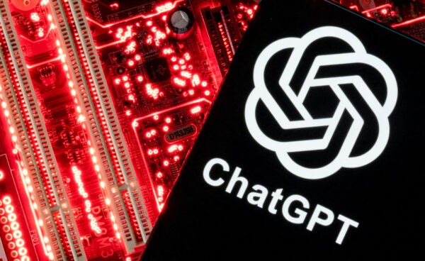 Смартфон с логотипом ChatGPT на фоне материнской платы компьютера. (Dado Ruvic/Reuters)