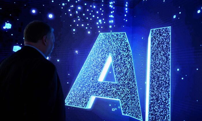 Посетитель наблюдает за надписью AI (искусственный интеллект) на анимированном экране на Всемирном конгрессе мобильных технологий (MWC), крупнейшем ежегодном собрании работников телекоммуникационной отрасли, в Барселоне. (Josep Lago/AFP via Getty Images)
