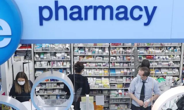 Фармацевты работают в аптеке «Лайф» 19 марта 2020 года. (Niall Carson/PA Media)
