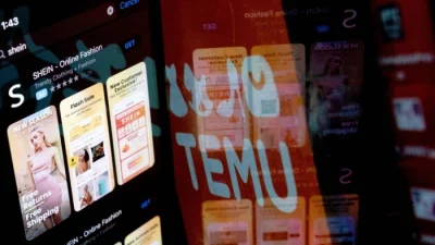 Приложение Shein в App Store, отражённое в логотипе Temu, Вашингтон, округ Колумбия, 23 февраля 2023 года. (Stefani Reynolds/AFP via Getty Images)