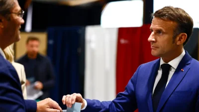 Президент Франции Эммануэль Макрон отдаёт свой бюллетень для голосования в первом туре досрочных парламентских выборов во Франции в Ле-Туке-Пари-Пляж, северная Франция, 30 июня 2024 года. (Yara Nardi, Pool via AP)