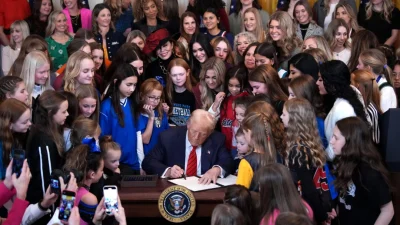 Президент Дональд Трамп в присутствии женщин-спортсменок подписывает указ «Ни одного мужчины в женском спорте» в Восточном зале Белого дома 5 февраля 2025 года. (Andrew Harnik/Getty Images)
