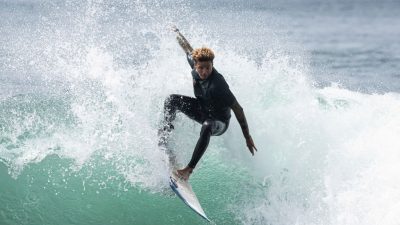 A surfer rides a wave during the Senegal Surf Championship in Dakar, on February 16, 2025. This championship marks the end of the surfing season and helps determine which surfers will represent Senegal at the Africa Surf Championship that will be held in Liberia on May 2025. (Photo by PATRICK MEINHARDT / AFP) (Photo by PATRICK MEINHARDT/AFP via Getty Images)