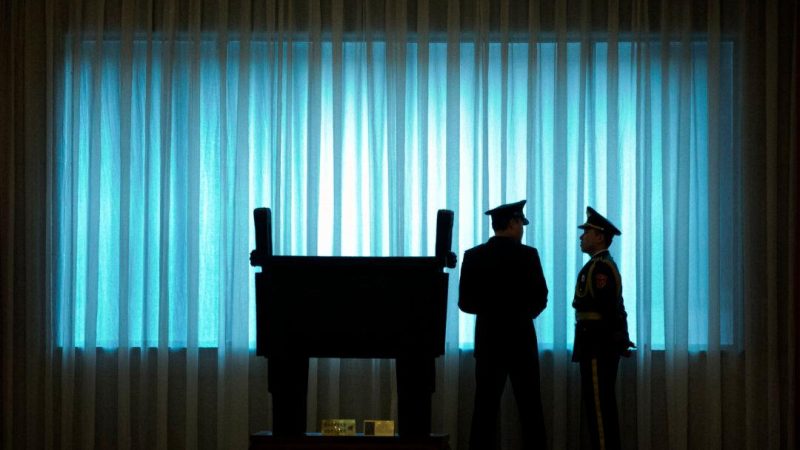 Офицеры Народно-освободительной армии Китая стоят у окна перед церемонией приветствия начальника штаба армии США генерала Марка Милли в здании Байи в Пекине, 16 августа 2016 года. (Mark Schiefelbein/POOL/AFP via Getty Images)