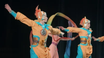 Танцоры Shen Yun в традиционных костюмах на сцене